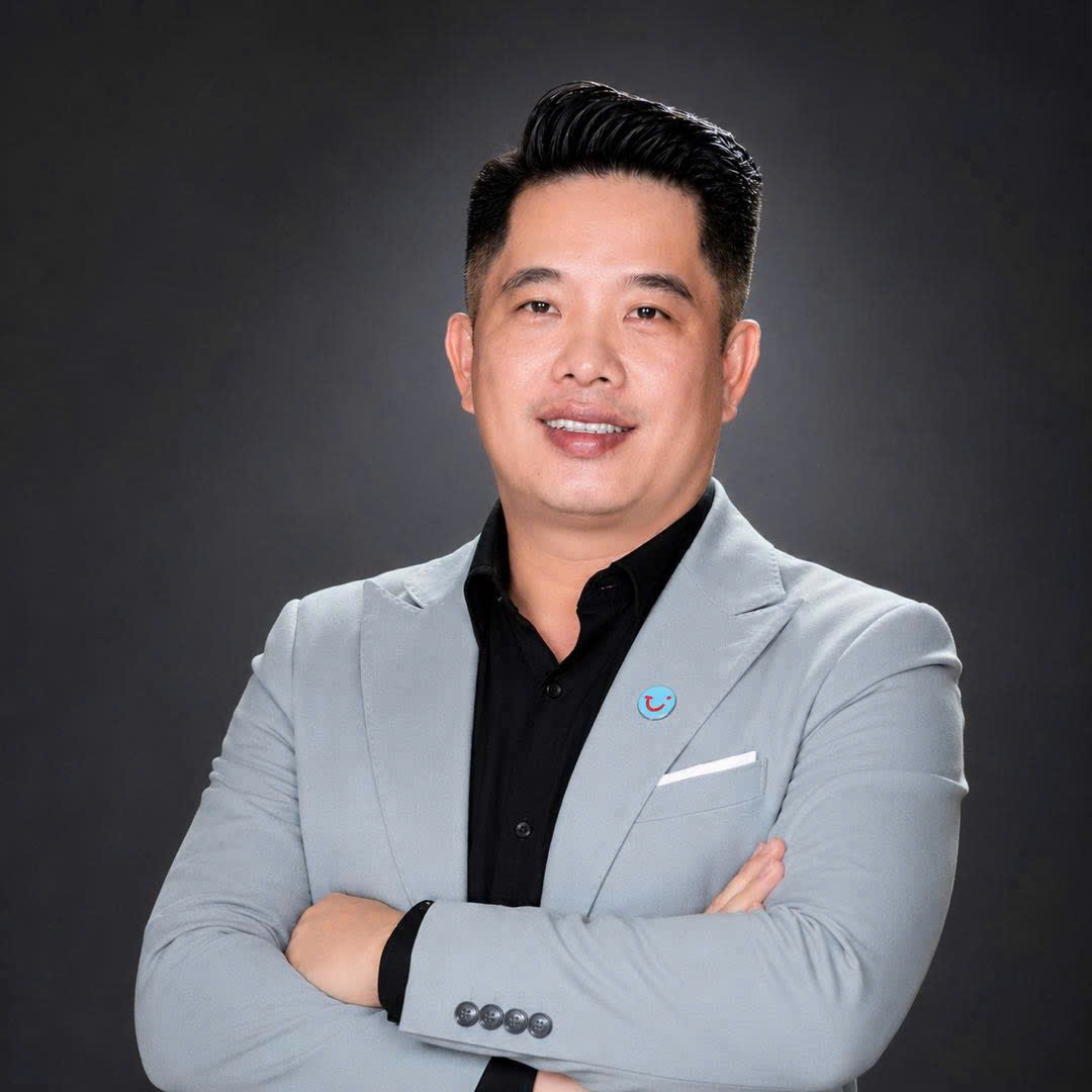 Duc Phan, Regional Business Development Director for APAC at TUI Hotels & Resorts, wearing a grey blazer with a TUI pin.