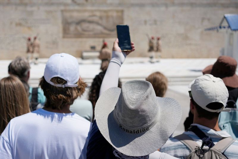 Hats Become Essential Gear in Athens as Tourism and Heat Collide