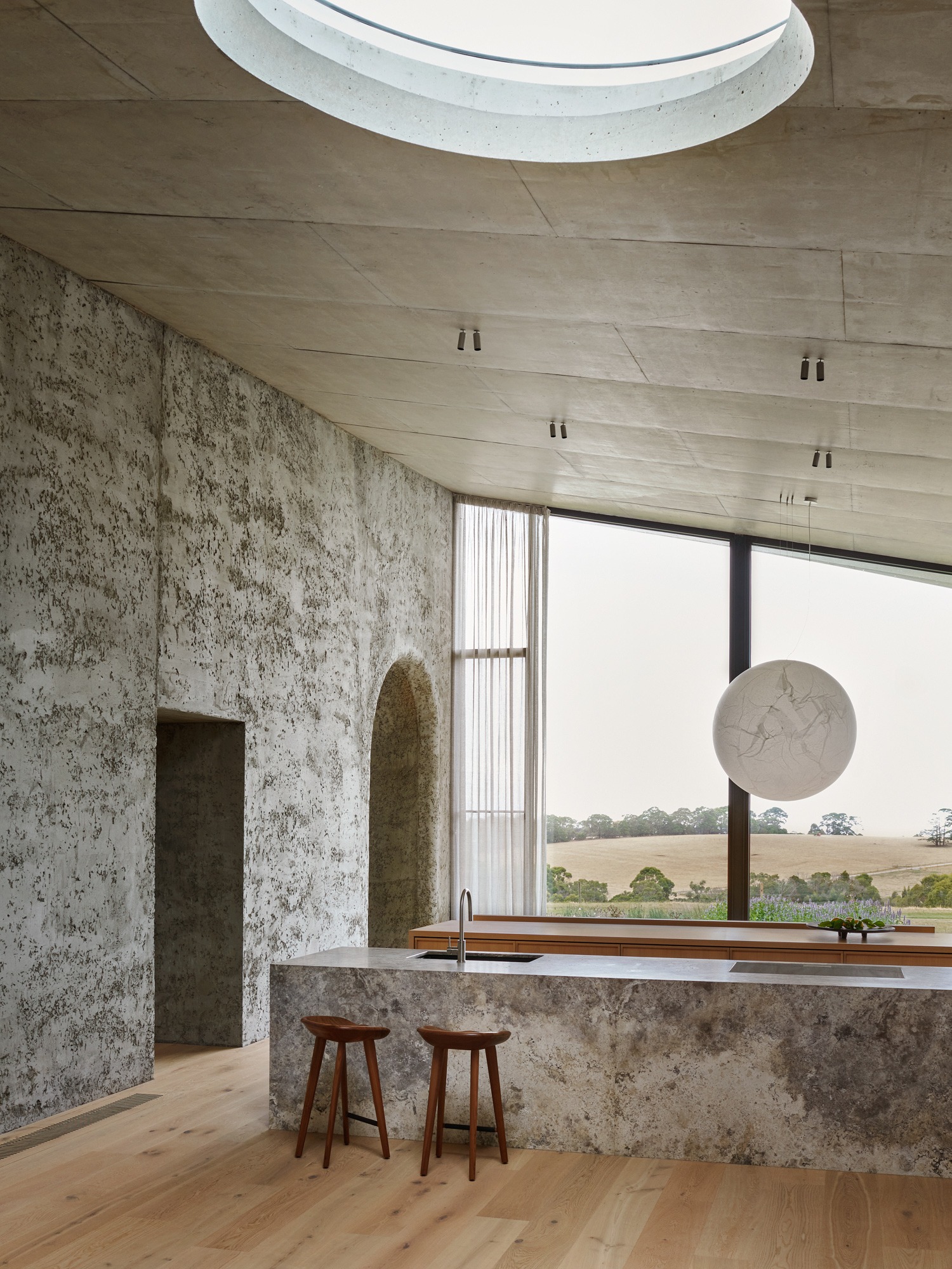 The Concrete Outcrop: Leeton Pointon's House on a Hill Emerges from the Landscape