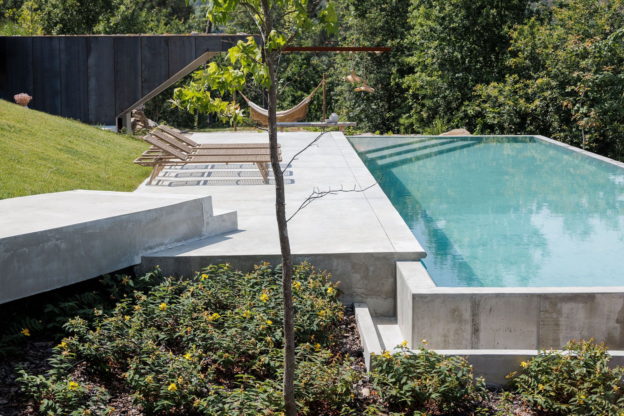 Casa Corten: A Weathered Steel Home That Grows From Portugal’s Hillside