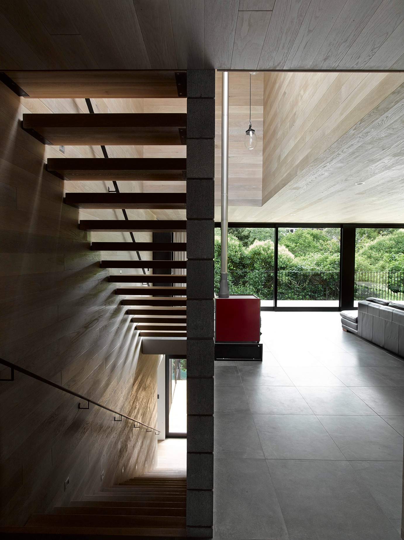 Waiatarua House by Monk Mackenzie Melds Steep Site with Silent Architecture