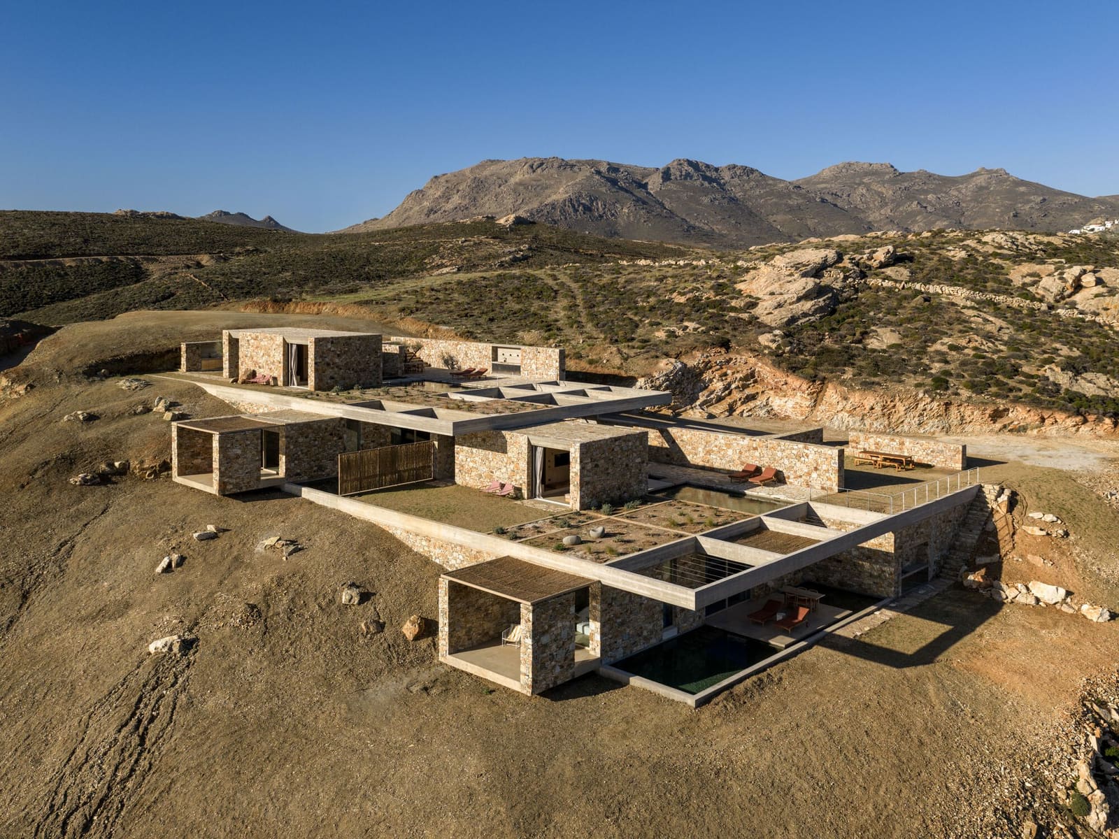How Five Stone Dwellings Redefine Hospitality on a Greek Island Hillside