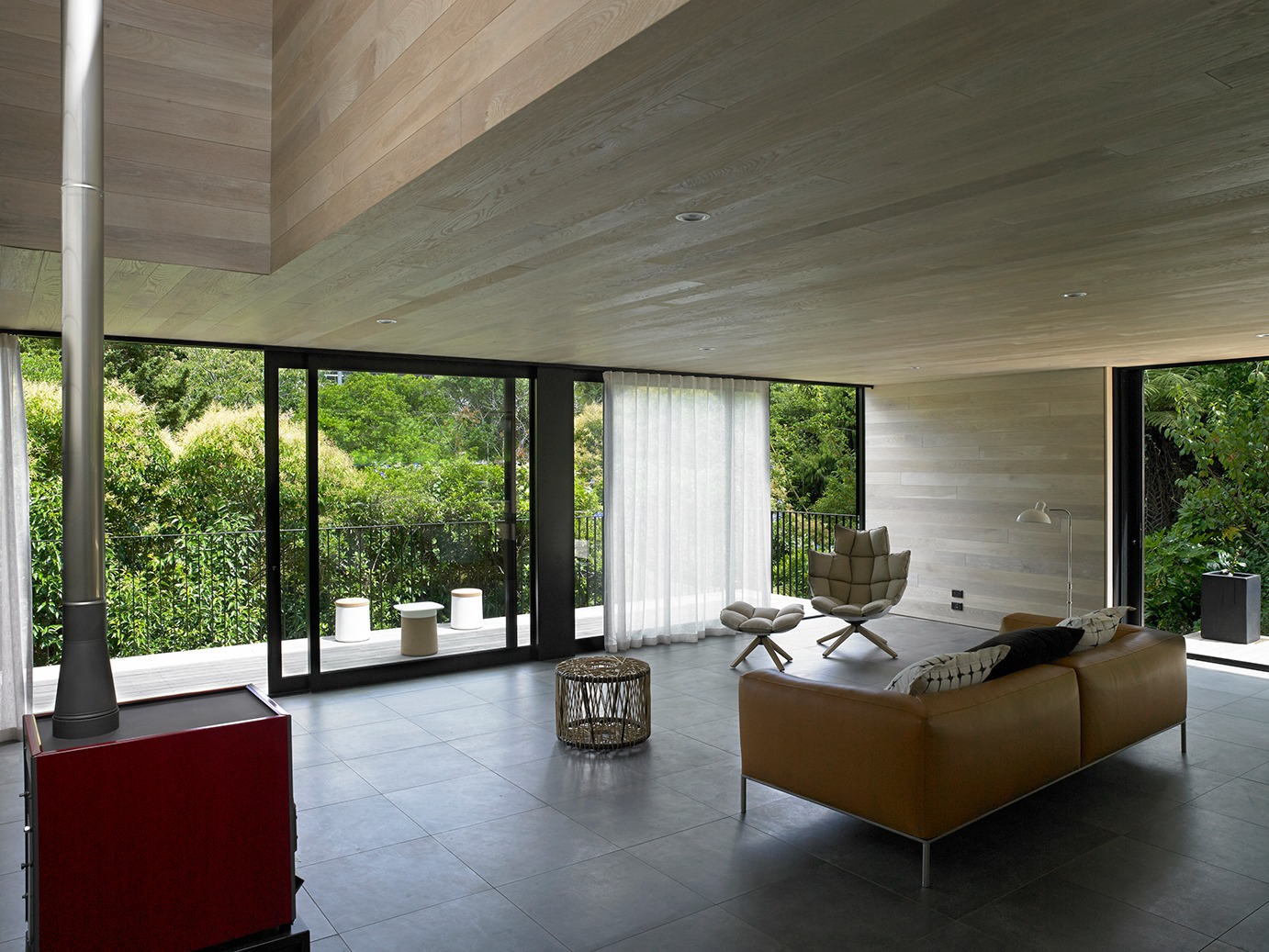 Waiatarua House by Monk Mackenzie Melds Steep Site with Silent Architecture