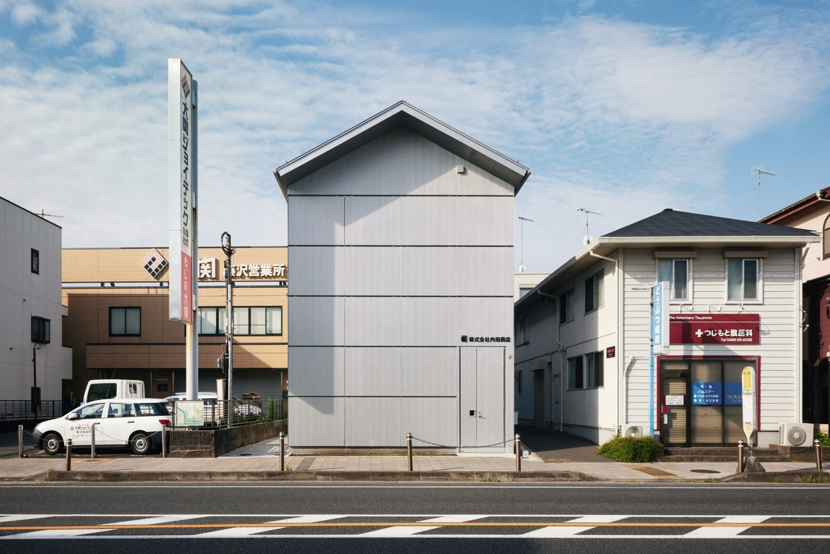 The Poetry of the Ordinary: Schemata Architects Wraps a Rice Dealer in Industrial Elegance